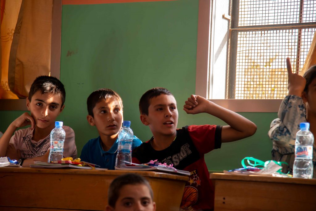 Børn i et klasseværelse på et børnecenter i Syrien modtager undervisning.